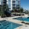 Spacious sparkling pool with sundecks and cabanas for lounging.